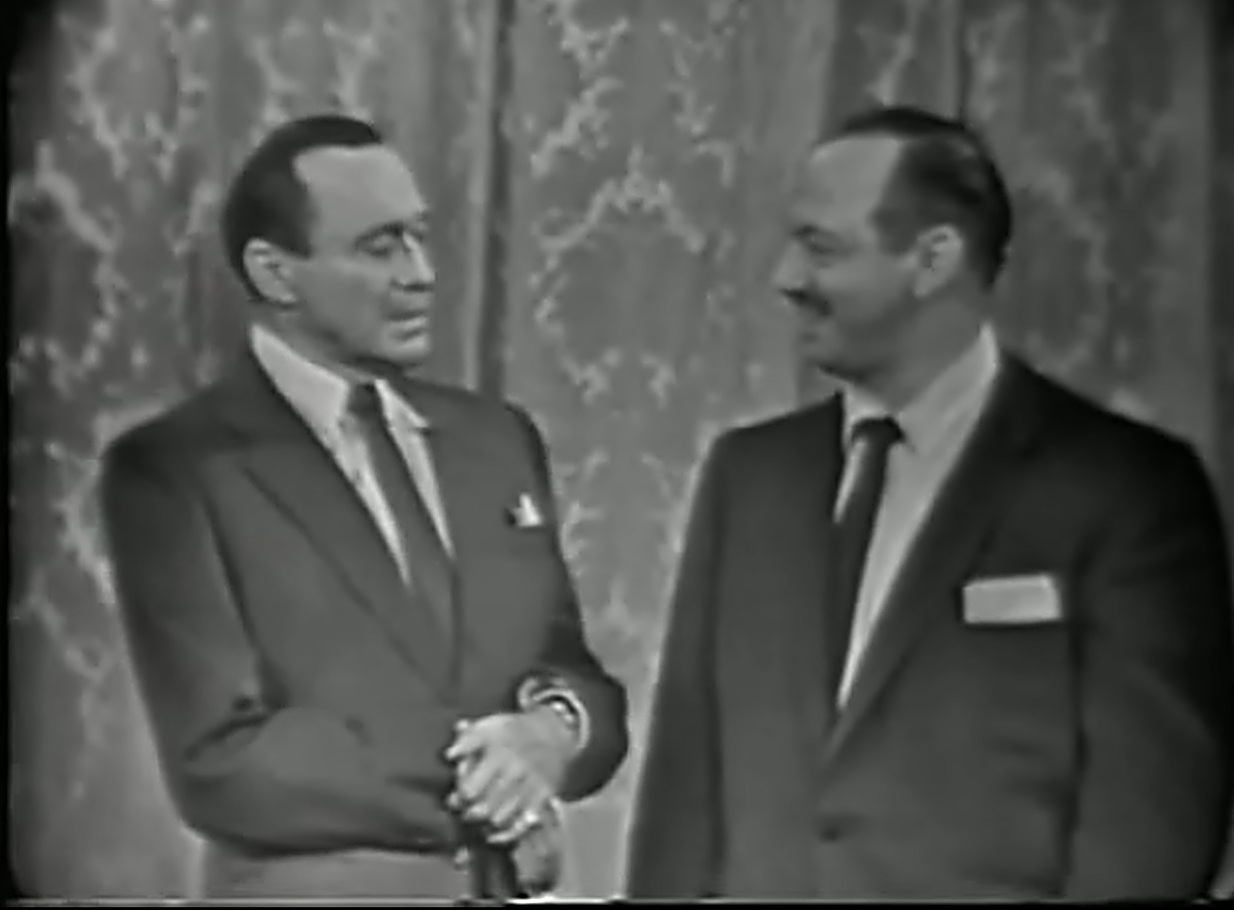 Jack Benny and Mel Blanc sharing a moment on stage