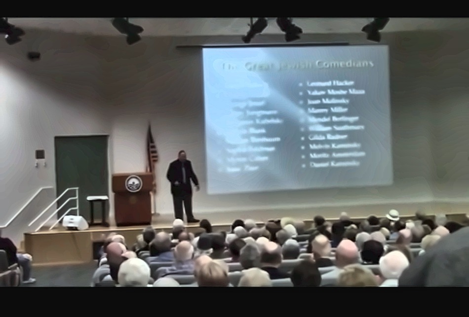 Al Kustanowitz presenting to a full auditorium at Florida Atlantic University's Osher Lifelong Learning Institute